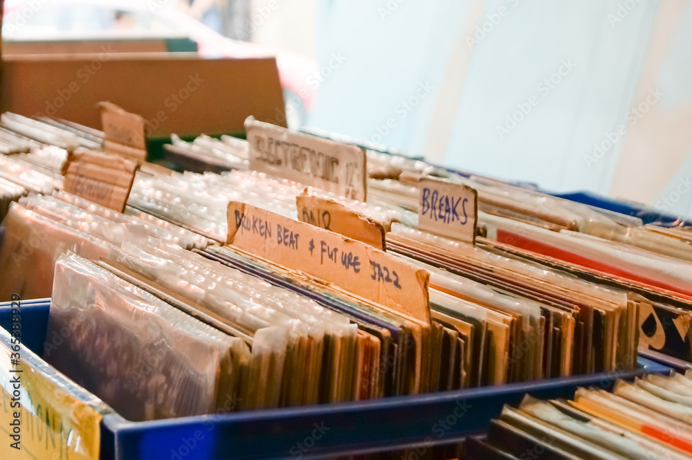 Music records in a crate for sale in a record store, separated by sub-genres.
Music records in a crate for sale in a record store, separated by sub-genres.