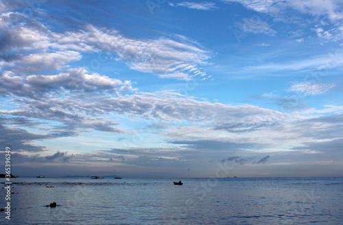View of dawn at the seaside with a man on the boat, Tioman Island © Crystaltmc