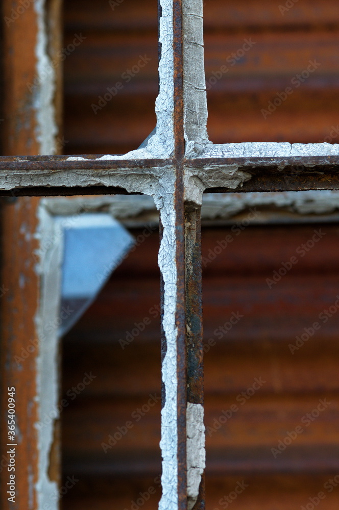 rusted window frame with remnants of glass rusted window frame with remnants of glass