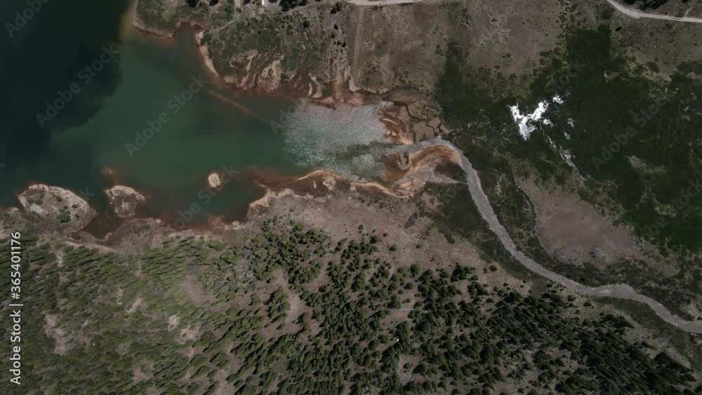 Top down aerial view moving shot, Scenic view of River stream ending in the lake in Aspen Colorado, surrounded by pine trees. Top down aerial view moving shot, Scenic view of River stream ending in the lake in Aspen Colorado, surrounded by pine trees.
