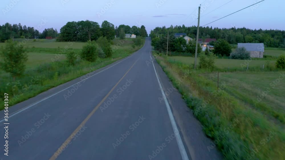 Drone shot following an isolated countryside road in Lanaudière, Québec, Canada Drone shot following an isolated countryside road in Lanaudière, Québec, Canada