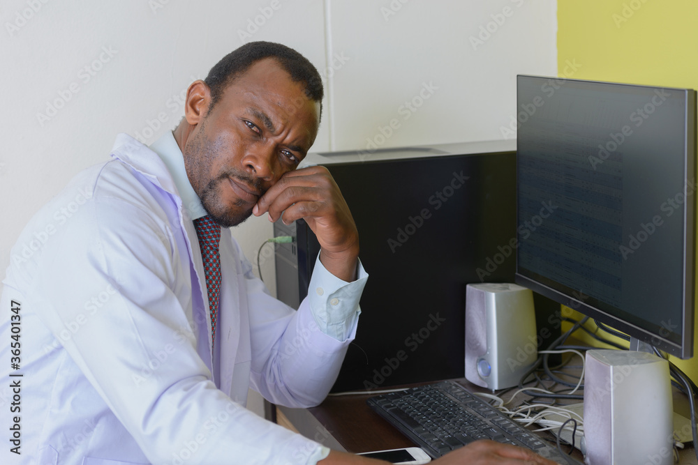 Handsome bearded African man doctor working in the office Handsome bearded African man doctor working in the office