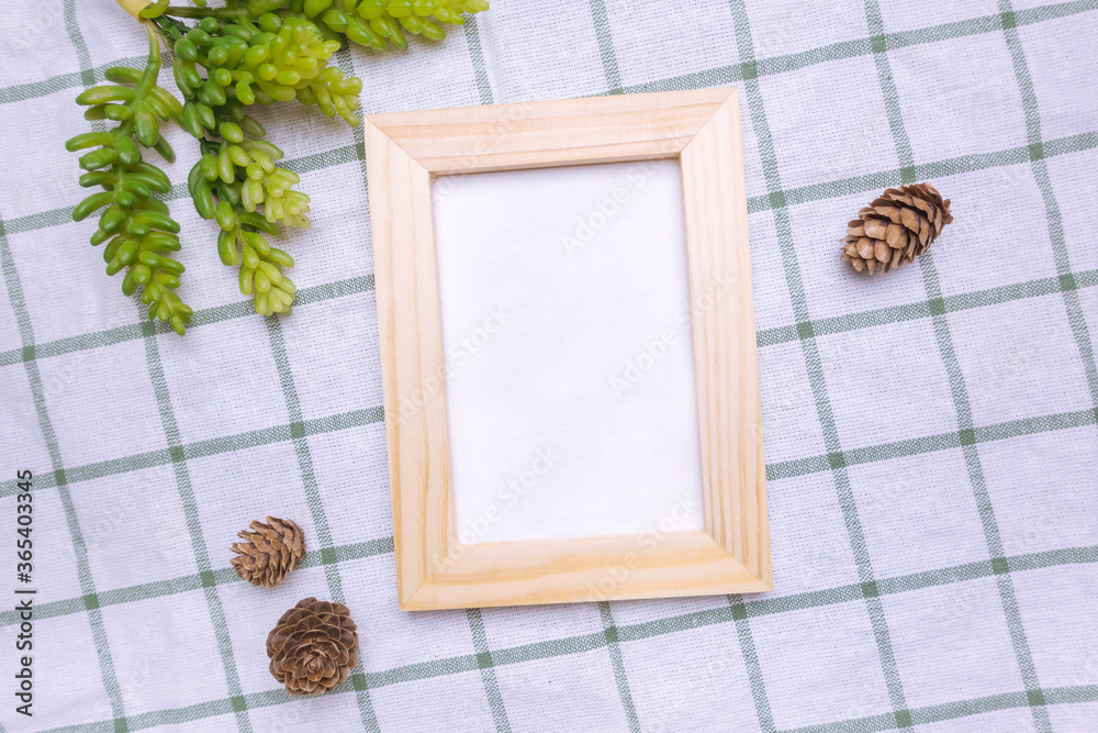 Fototapeta premium Top view of nature wooden photo frame on table. 