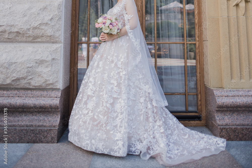 bride wedding bouquet near classical architecture