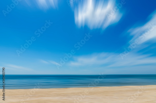 Motion of the sky and sea with soft white clouds.