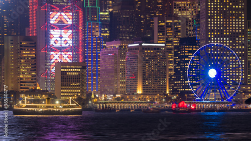 Canvas Print Luxury large touring boat for tourist service in victoria harbor at night view from Kowloon side at Hong Kong