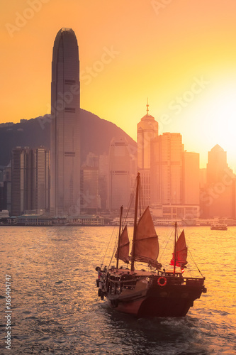 Hong Kong traditional tourists boat for tourist service in victoria harbor with city view in background at sunset,view from Kowloon side at Hong Kong