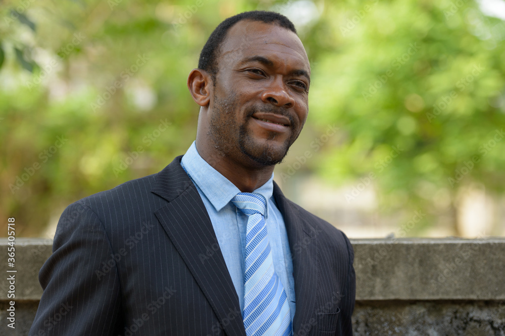Portrait of handsome bearded African businessman outdoors Portrait of handsome bearded African businessman outdoors