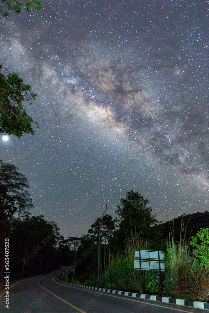 The beautiful Milky way over the road in the dark night.
