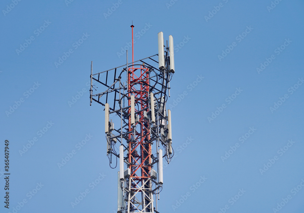 Telecommunication tower of 4G and 5G cellular. Macro Base Station. Wireless Communication Antenna Transmitter. Telecommunication tower with antennas against blue sky background. Telecommunication tower of 4G and 5G cellular. Macro Base Station. Wireless Communication Antenna Transmitter. Telecommunication tower with antennas against blue sky background.