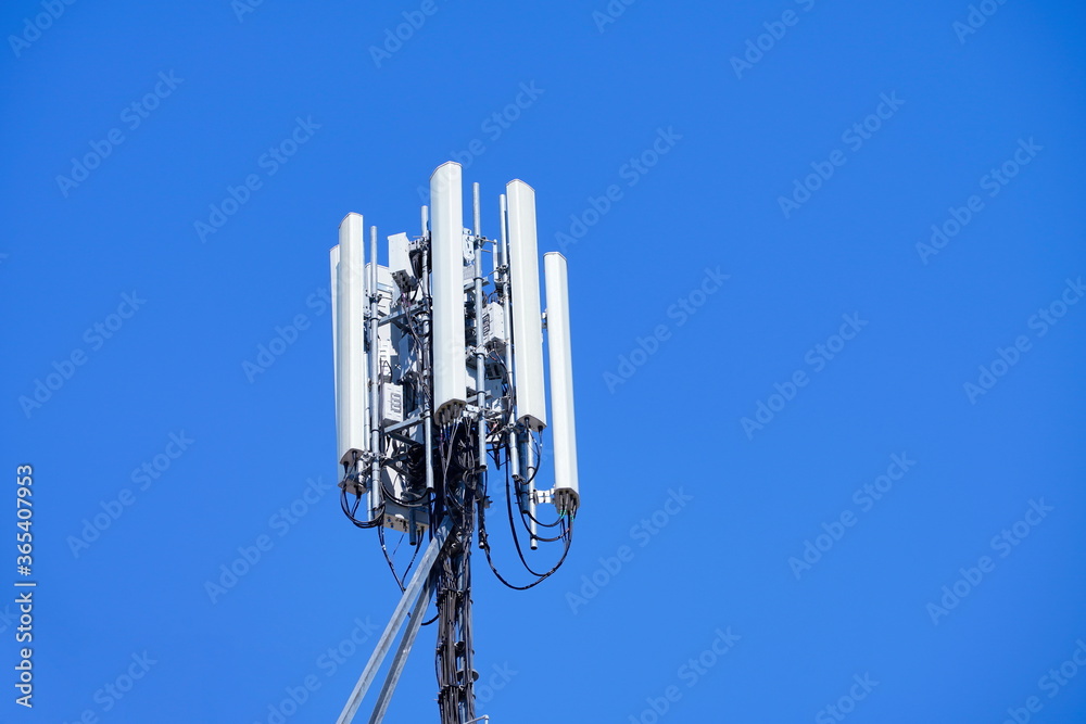 Telecommunication tower of 4G and 5G cellular. Macro Base Station. Wireless Communication Antenna Transmitter. Telecommunication tower with antennas against blue sky background. Telecommunication tower of 4G and 5G cellular. Macro Base Station. Wireless Communication Antenna Transmitter. Telecommunication tower with antennas against blue sky background.