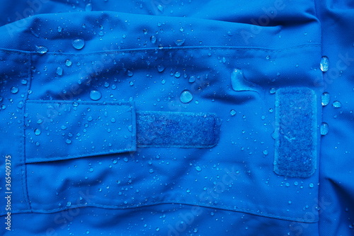 Foto Closeup of water drops on dark blue fabric and sticky straps with waterproof des
