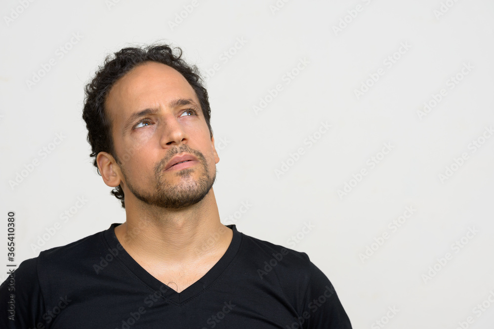 Portrait of handsome bearded Hispanic man with curly hair Portrait of handsome bearded Hispanic man with curly hair