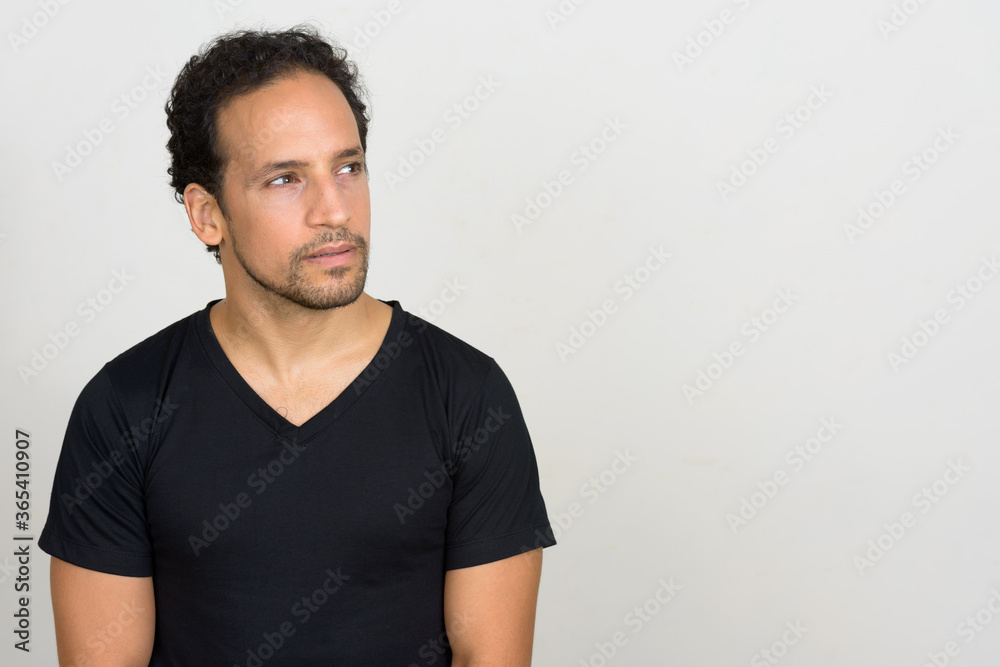 Portrait of handsome bearded Hispanic man with curly hair Portrait of handsome bearded Hispanic man with curly hair