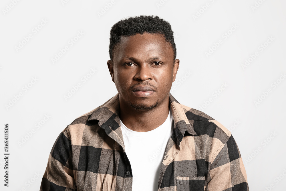 Sad African-American man on light background. Stop racism Sad African-American man on light background. Stop racism