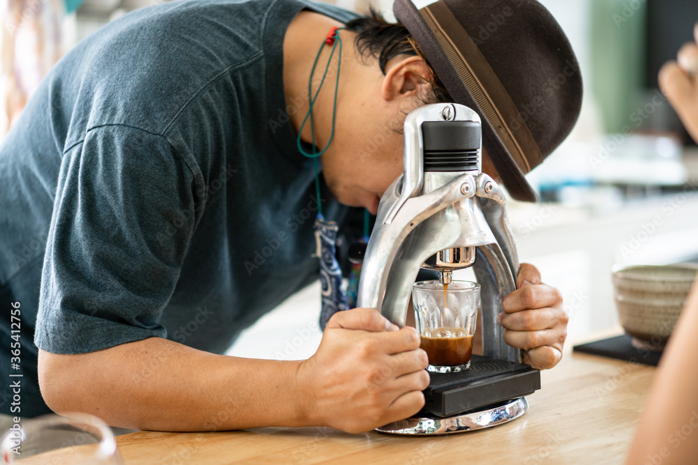 Barista use manual process to make espresso with classic espresso machine Barista use manual process to make espresso with classic espresso machine