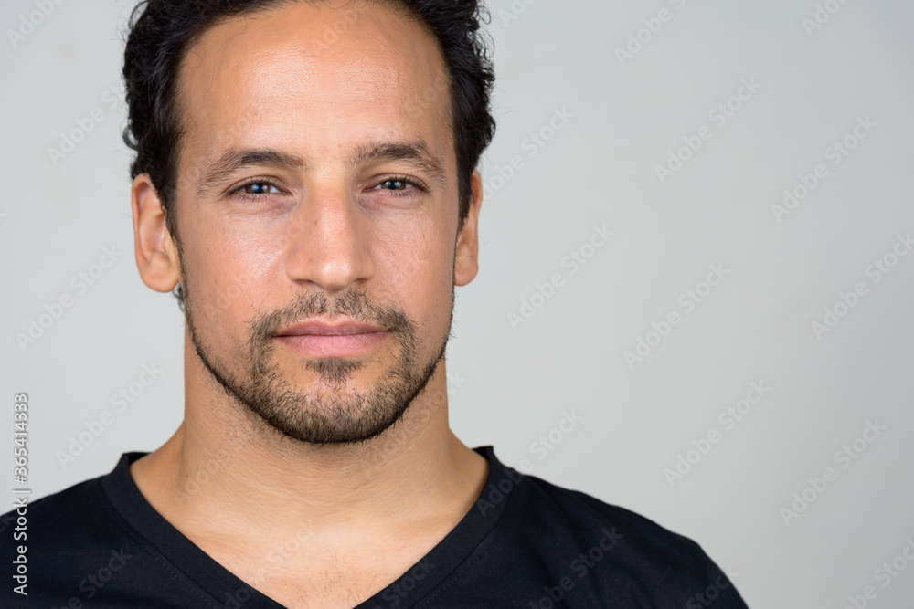 Portrait of handsome bearded Hispanic man with curly hair Portrait of handsome bearded Hispanic man with curly hair