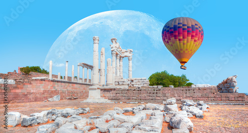 Fototapeta Naklejka Na Ścianę i Meble -  Hot air balloon flying over Pergamon - Akropolis antique city of Pergamon with full moon - Bergama, Turkey 