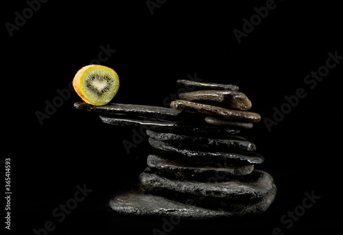 
Creative pictures of fresh kiwis on slate and black background photo