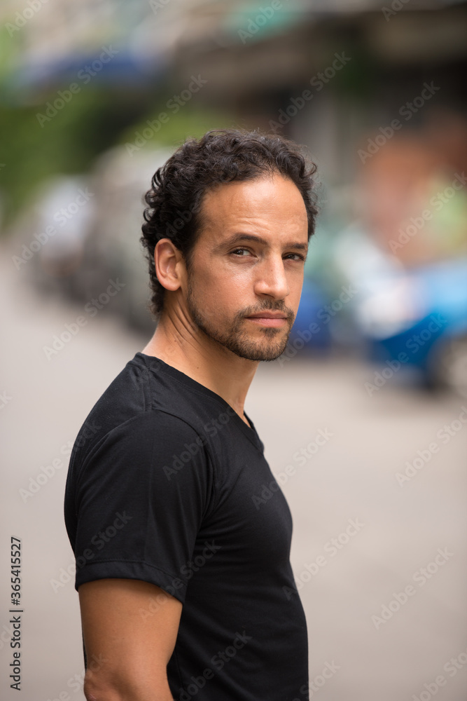 Handsome bearded Hispanic man in the streets outdoors Handsome bearded Hispanic man in the streets outdoors