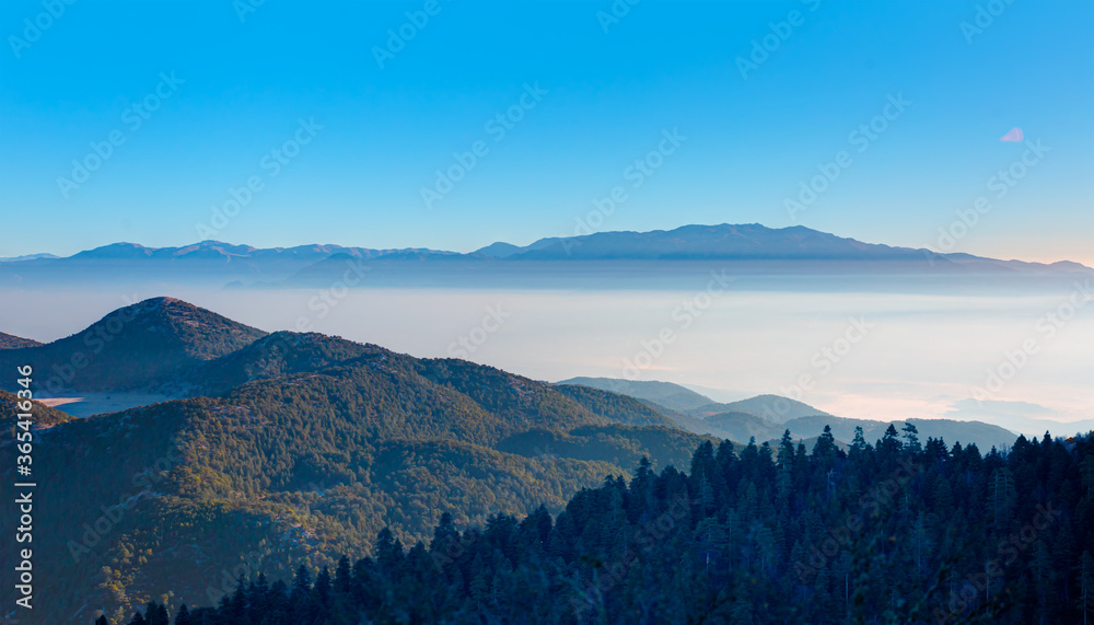 Misty view of the blue mountain range -  Beautiful landscape with cascade blue mountains at the morning - Fethiye, Turkey