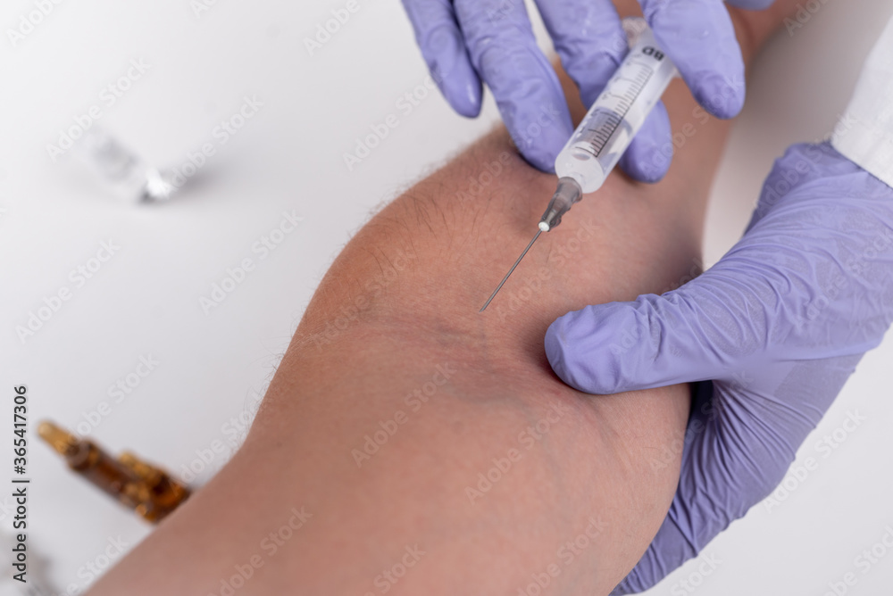 blue-gloved healthcare worker administers syringe vaccine blue-gloved healthcare worker administers syringe vaccine