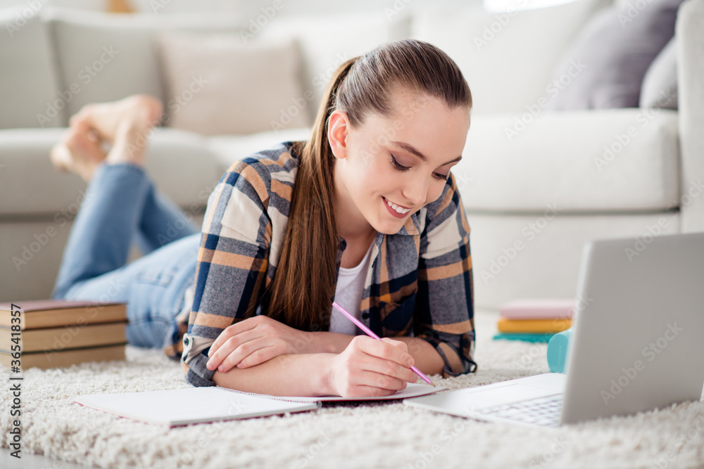 Photo of pretty lady student browsing notebook lying floor carpet video call listen teacher lesson online conference education writing notes diary homework social distance quarantine indoors Photo of pretty lady student browsing notebook lying floor carpet video call listen teacher lesson online conference education writing notes diary homework social distance quarantine indoors