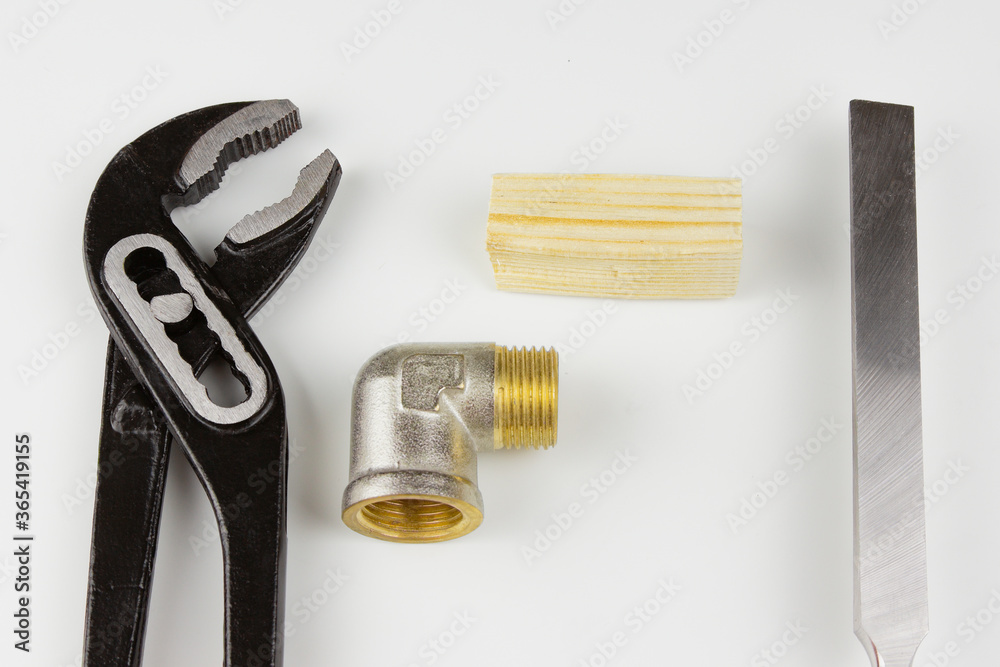 Black pliers chisel and plumbing metal corner on a white background. Black pliers chisel and plumbing metal corner on a white background.