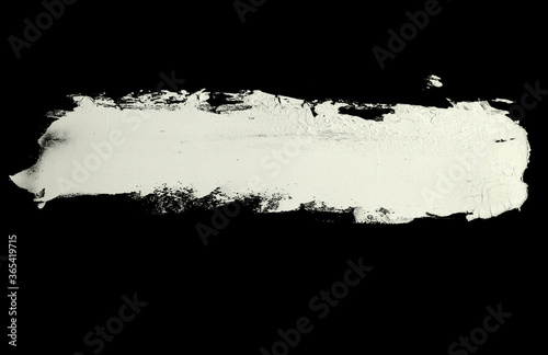 Brushstroke with a thick white paint, isolated on a black background.