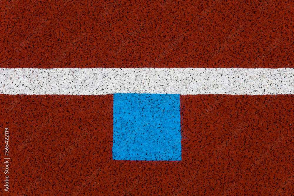 Fototapeta premium Red stadium running track closeup