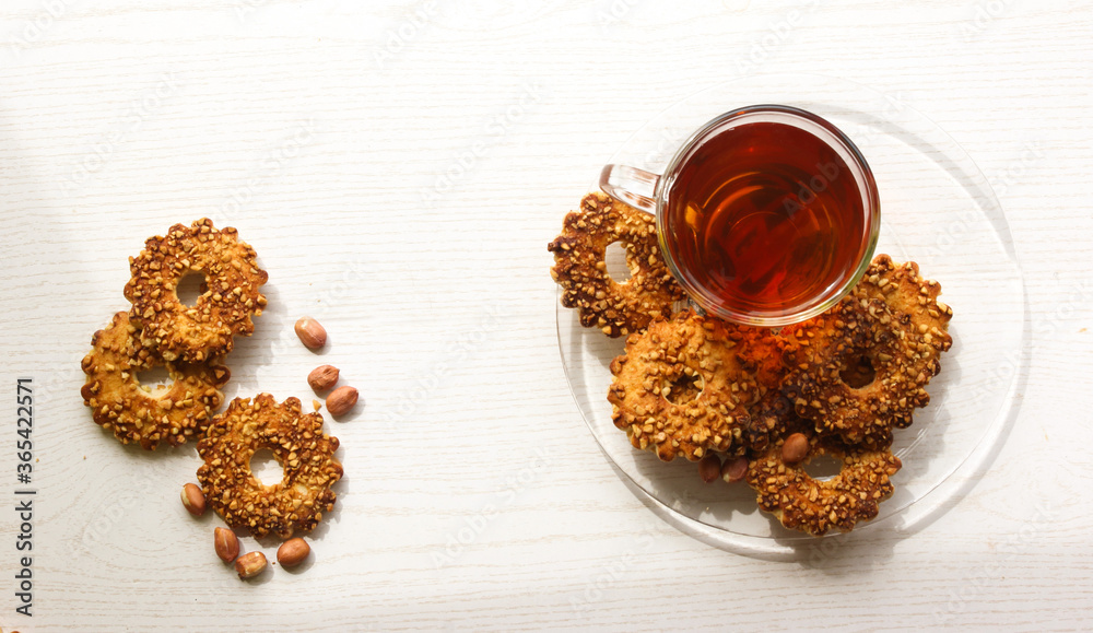 Top of view breakfast cup of tea with nuts biscuits on white background Top of view breakfast cup of tea with nuts biscuits on white background