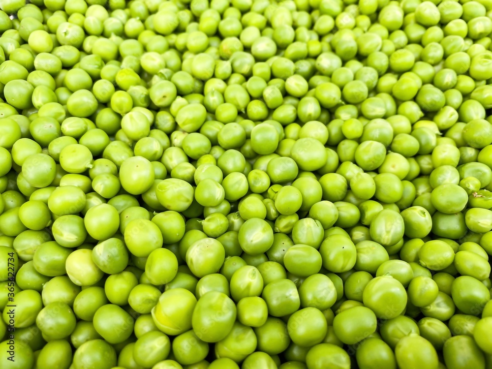 Grains of raw green peas in a metal bowl. Concept of healthy food, agriculture.