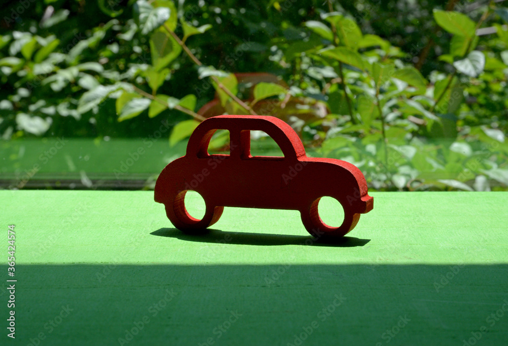 red toy car on the green grass