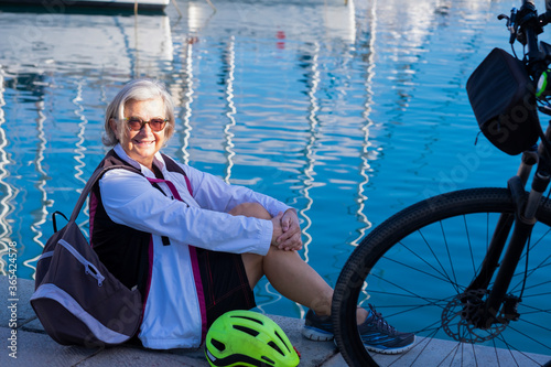 Принти на полотні Smiling and relaxed senior adult woman with silver hair enjoys the excursion to