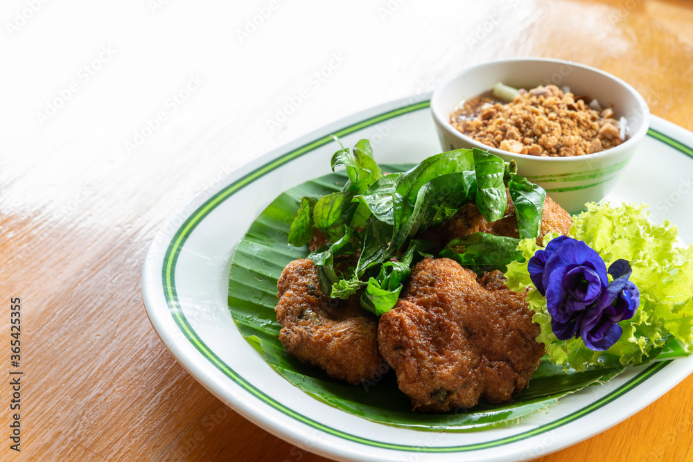 Fried Fish-Paste Balls with fresh vegetable on wooden table. Thai Traditional Foods. Fried Fish-Paste Balls with fresh vegetable on wooden table. Thai Traditional Foods.