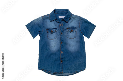 Denim shirts isolated. Close-up of a male stylish faded blue jeans shirt for kids isolated on a white background. Short sleeve shirt summer fashion. © Olga