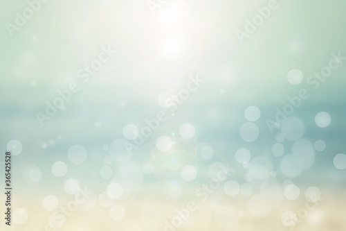 Abstract sea background. Abstract tropical sandy summer beach background with bokeh lights on light blue sky and sun. Beautiful texture. Space.