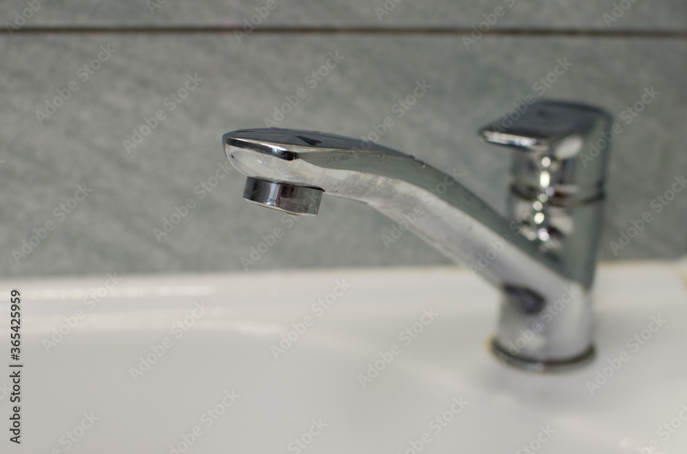 water flowing from faucet in bathroom