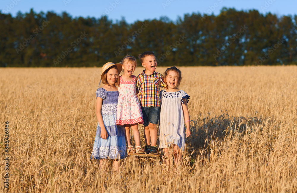 four kids having fun in field