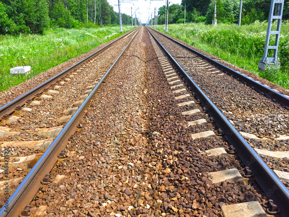 rails of the railway track in summer in Sunny weather stretch into the distance