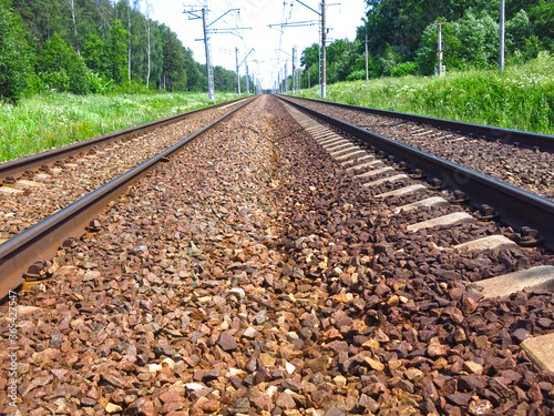 rails of the railway track in summer in Sunny weather stretch into the distance