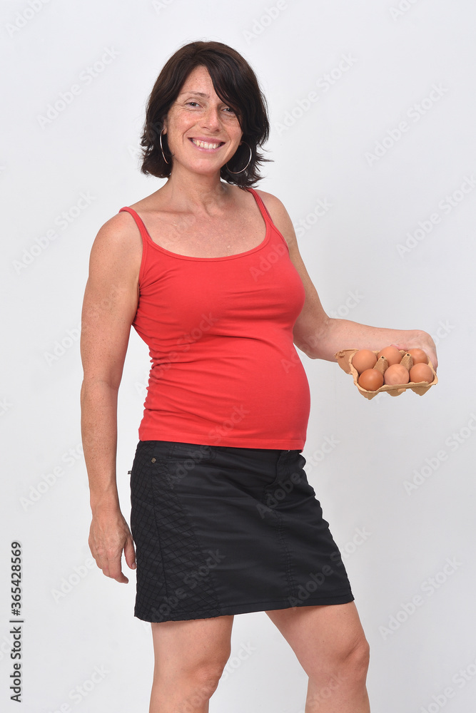 pregnant woman holding eggs on white background pregnant woman holding eggs on white background