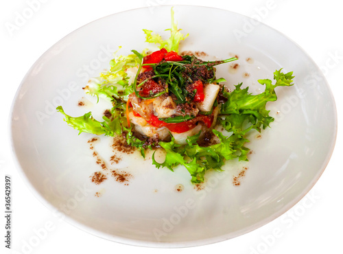 Codfish timbale with fried red peppers, arugula and olive oil. Isolated over white background