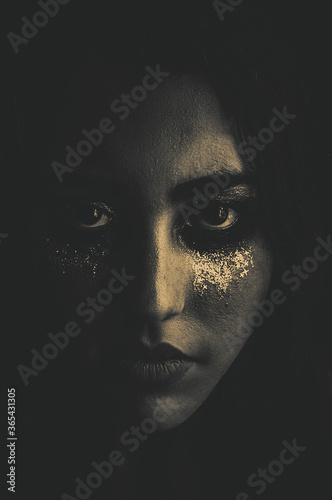 Black and white dark moody portrait of a beautiful and sexy woman face. Make up with shiny glitter tears. Beautiful crying. Concept of sadness, despair, pain, and drama queen. Retro style. 