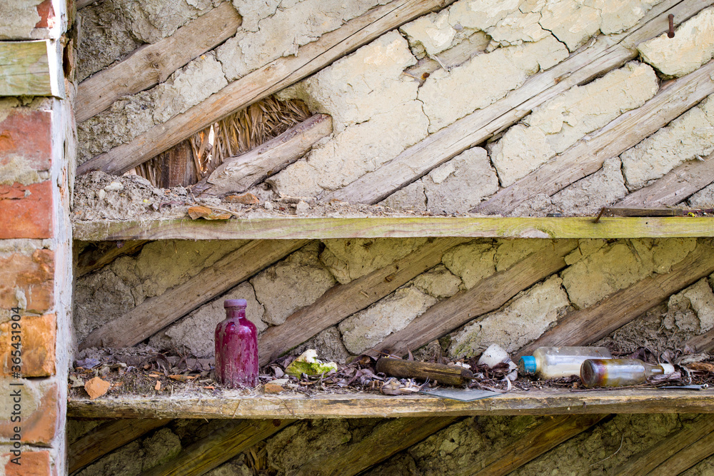 Shelf with old things in a ruined wooden house in an abandoned village