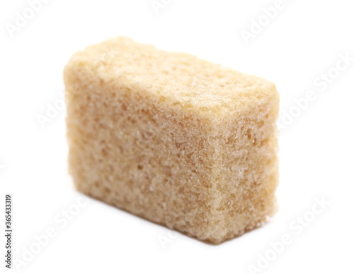 Brown cane sugar cube isolated on white background