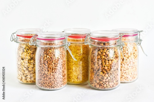 Healthy vegan food, seeds and grains in jars isolated on white background. peas, buckwheat, oatmeal, rice and buckwheat. healthy eating concept.