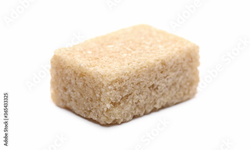 Brown cane sugar cube isolated on white background