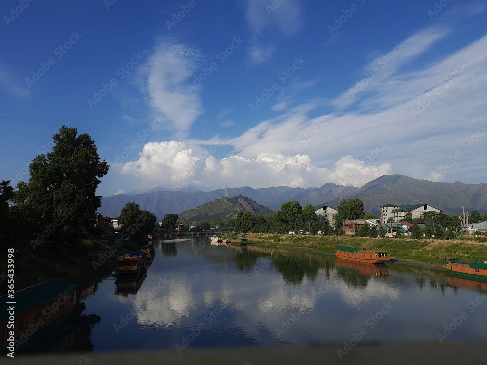 Fototapeta premium River with crystal clear water with mountains in background