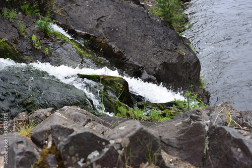 Fotografie Kivach waterfall divided into arms flowing through the rocks